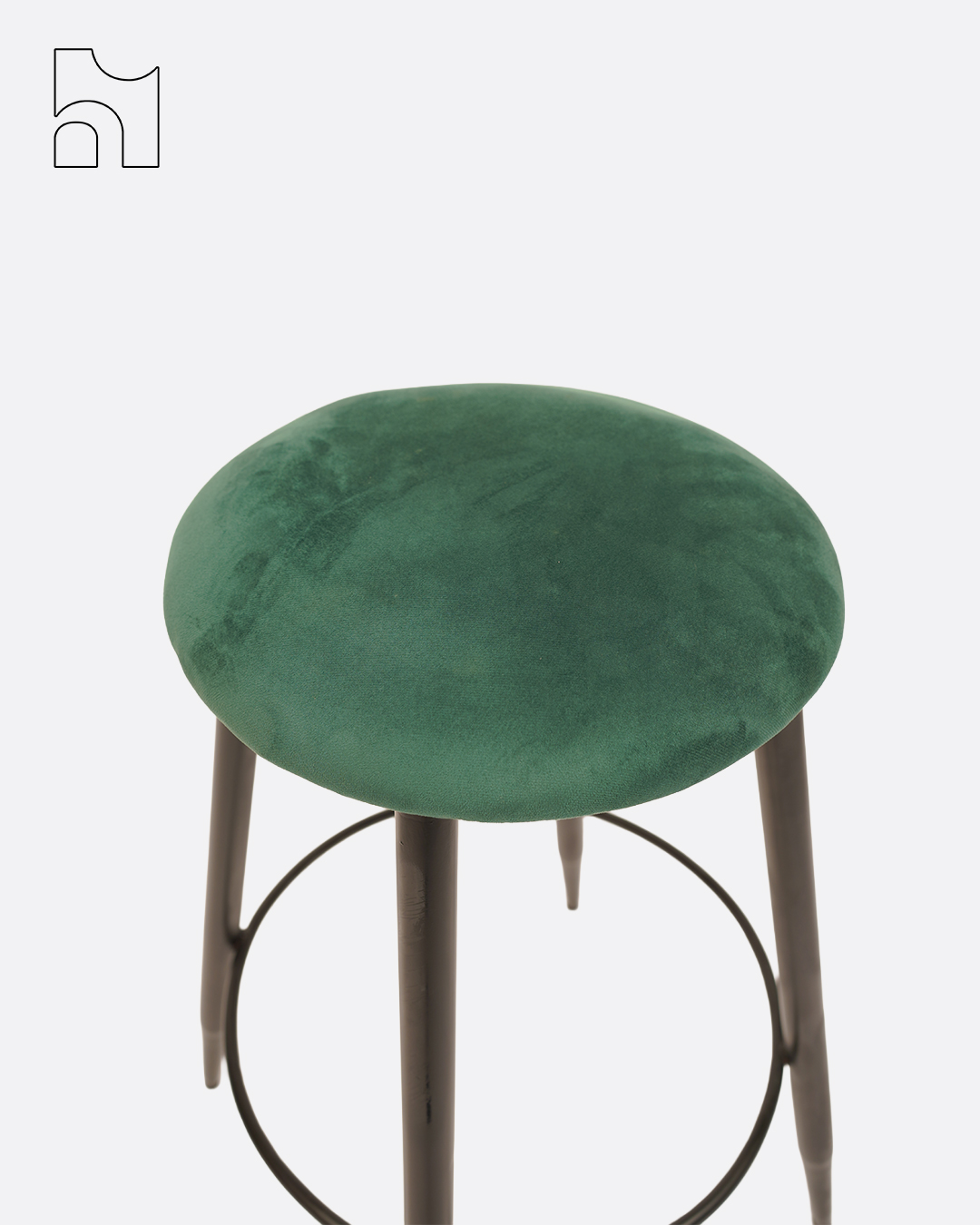 Shop the VelvetLoft Bar Stool with green velvet seat and black metal legs. Perfect for kitchen counters, home bars, and cafés seeking stylish, compact seating.